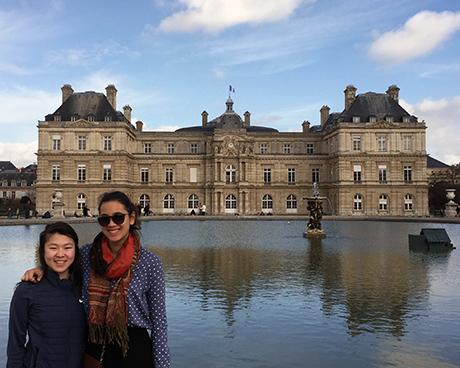 two students pose in front of jardin luxembourg, paris