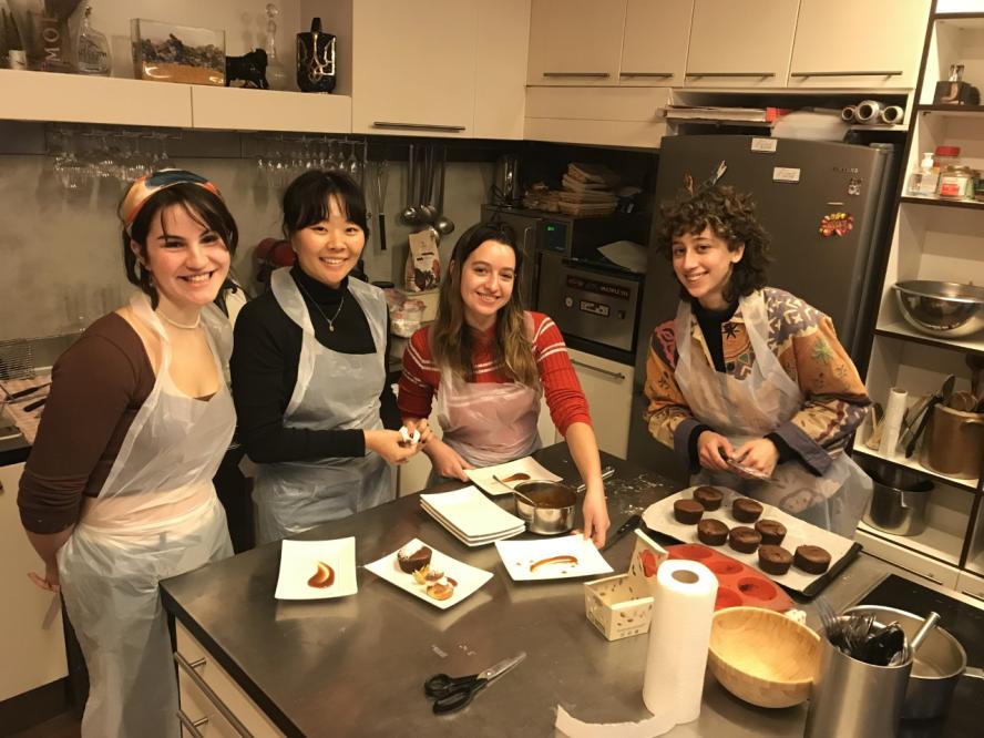 four students participating in a cooking class in paris