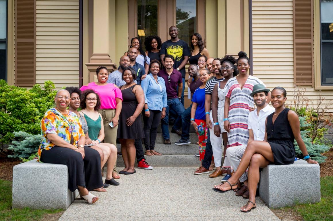 Alumni in a group photo outside of building