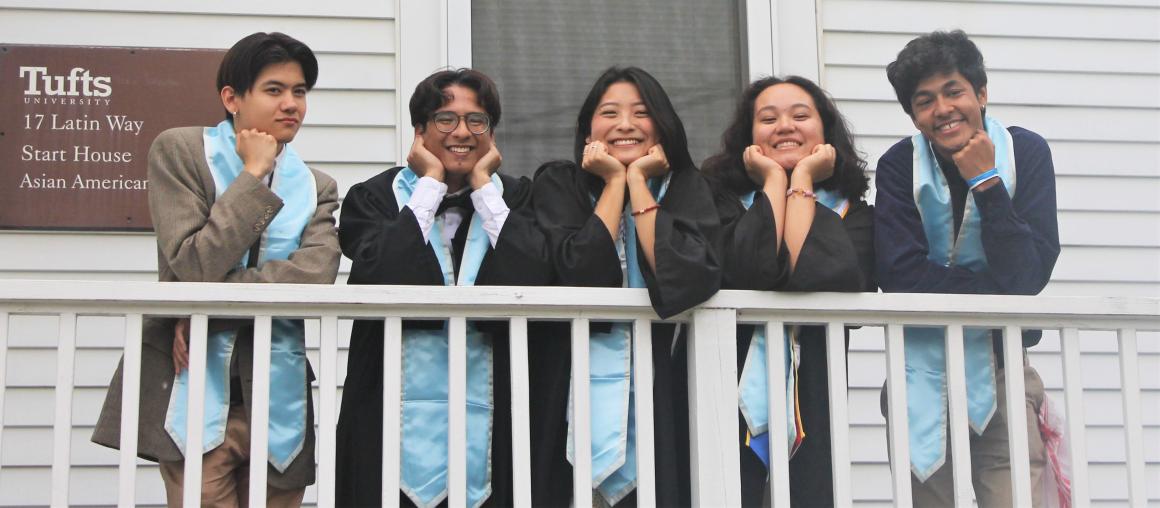 five students pose on the Asian American Center porch with their graduation stoles