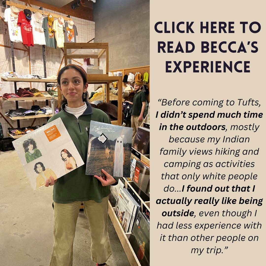 Image of TWO Leader Becca holding 2 records in a clothing store, with text that says "Click here to read Becca's experience. Before coming to Tufts, I didn’t spend much time in the outdoors, mostly because my Indian family views hiking and camping as activities that only white people do...I found out that I actually really like being outside, even though I had less experience with it than other people on my trip."
