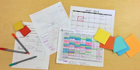 Filled-in calendar, Post-It notes, and pens