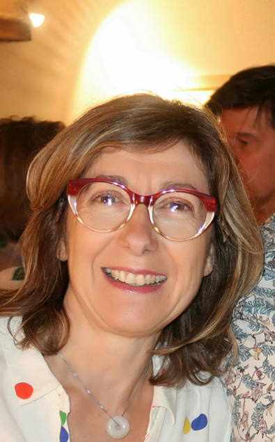 close-up of Tufts in Paris Director Jeanne Fourneyman wearing white shirt and red glasses