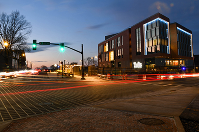 An intersection near campus at sunset