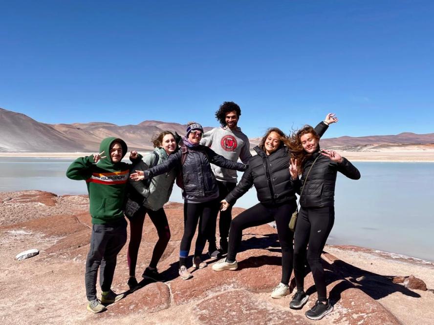 group of 6 students posing at atacama desert in chile