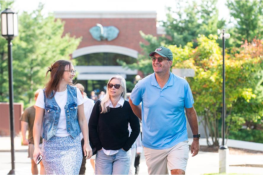 Family walking in front of Dowling Hall